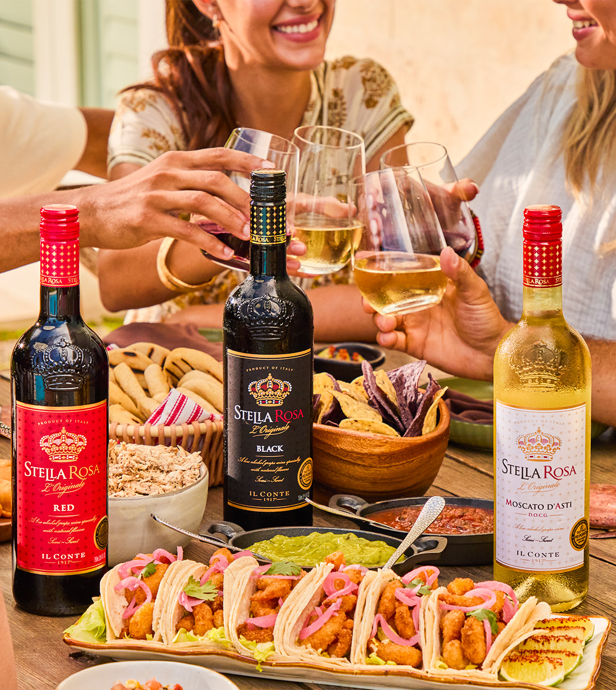 Group of people eating tacos and drinking Stella Rosa wines